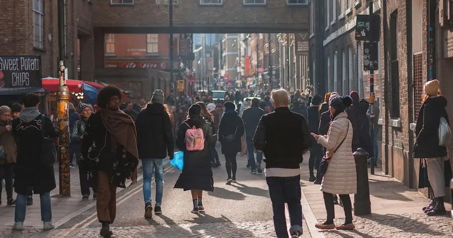 Photo of street with lots of people walking