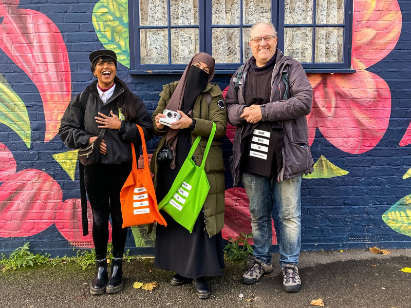 An image of three people smiling into the camera