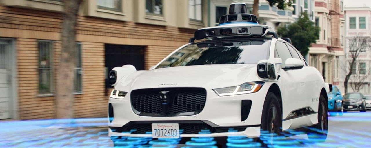 An autonomous veichles drives through a neighbourhood emitting invisible signals