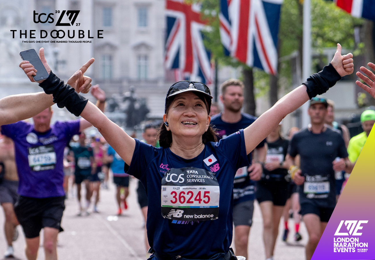 A woman with her arms raised running the London Marathon. Union jack flags and other runners are in the background. The London Marathon Events logo is in the bottom left hand corner, with the Double TCS London Marathon logo in the top right hand corner. 